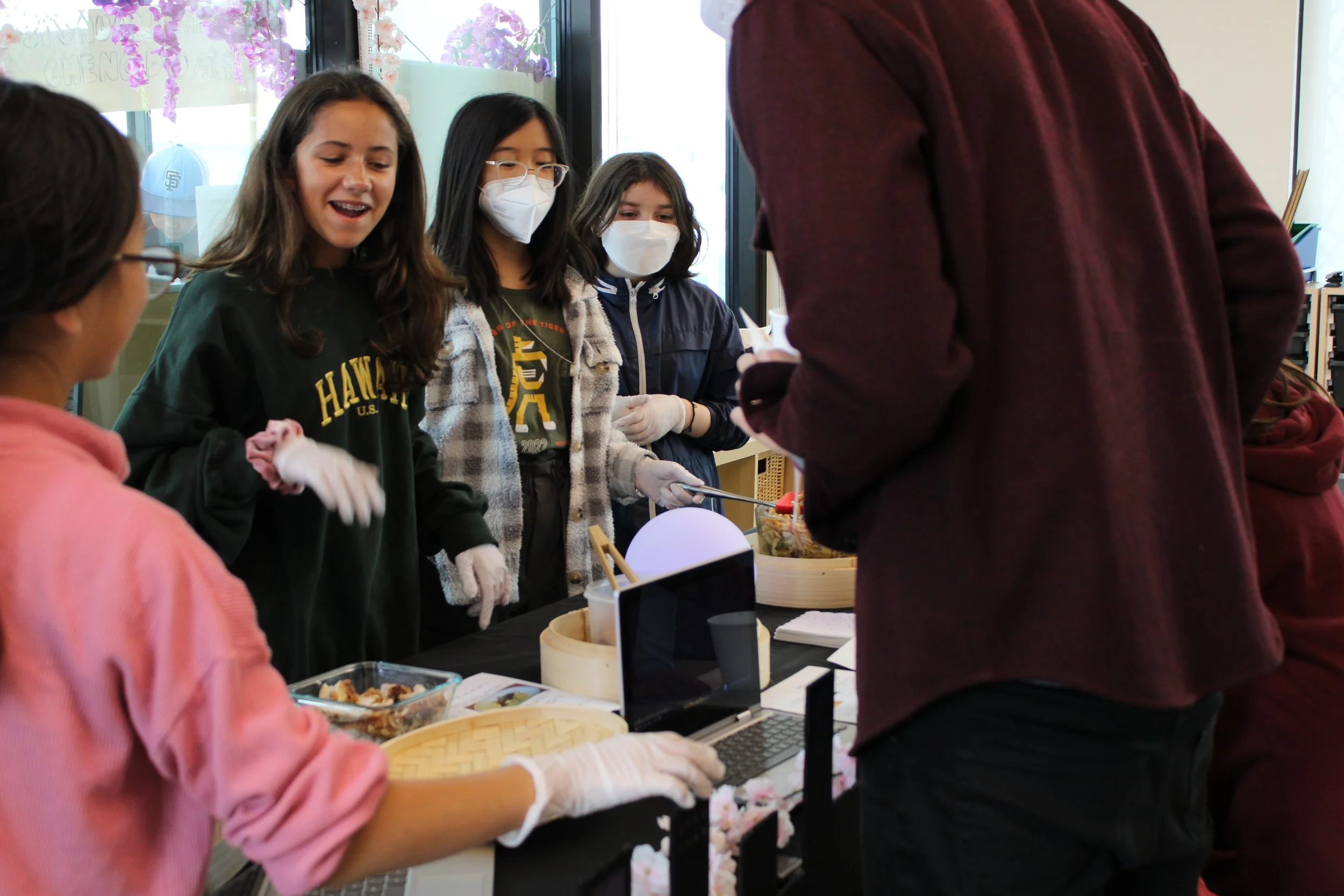  7th Grade showing off the food they made for their regional food project. 