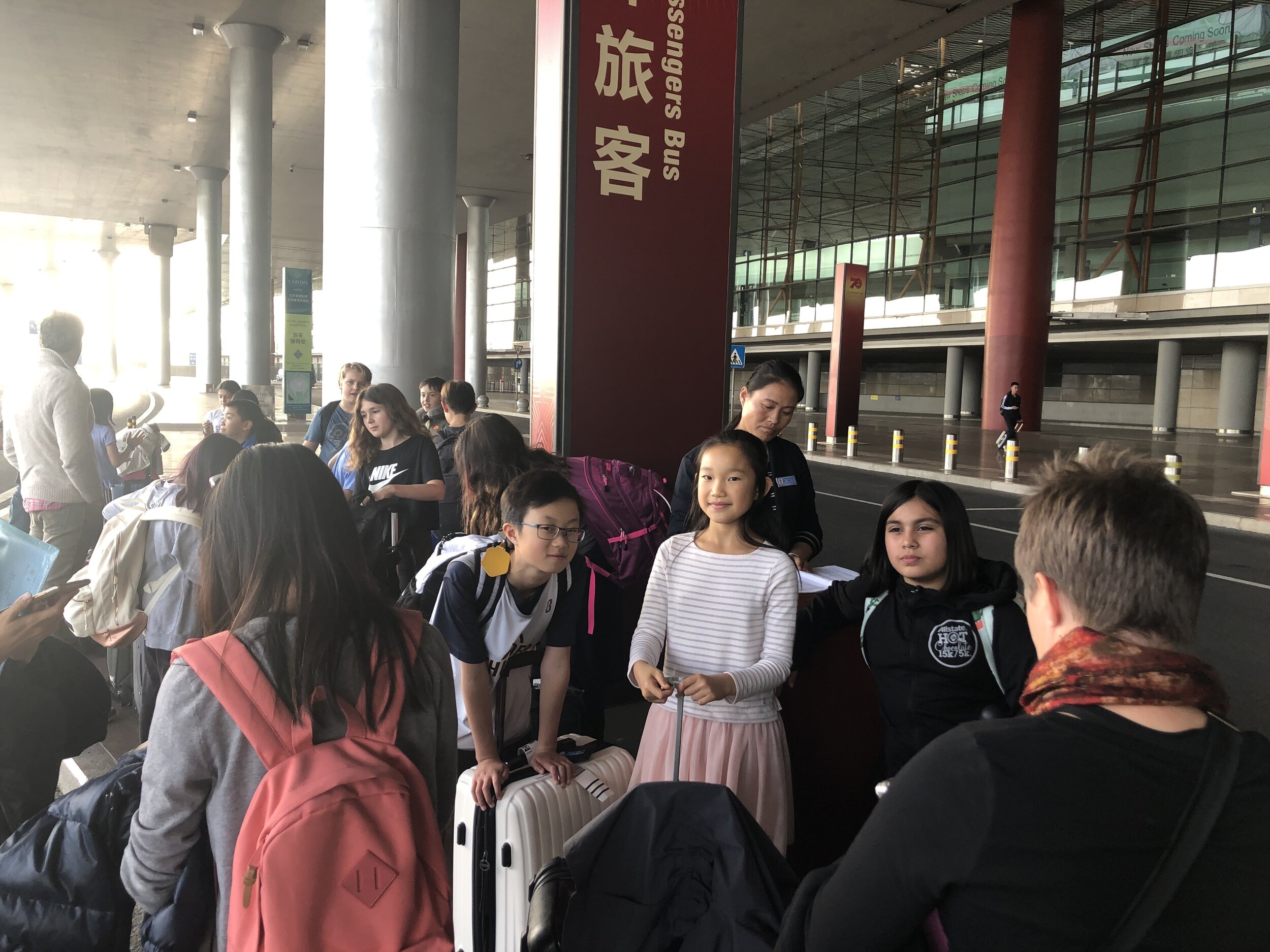   The group waits for our bus outside of the airport.  